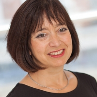Head shot of Louise Garcia smiling and looking away from camera